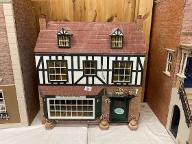An Elizabethan style dolls house shop (tea room and fireside shop) and contents
