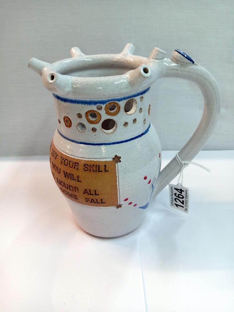 A Hilbre View pottery flint puzzle jug. Height 20cm. A/F
