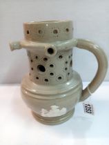 A 19th century stoneware jasperware puzzle jug, Height 20cm (handle repaired)
