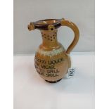 A Doulton Lambeth stoneware puzzle jug. Height 17cm. A/F