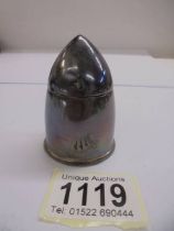 A silver bullet shaped inkwell.