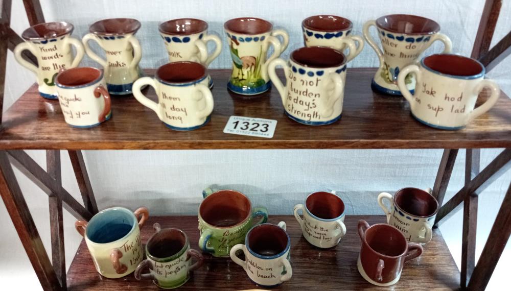 2 shelves of Torquay ware small loving cups