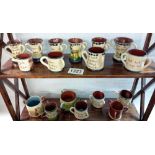 2 shelves of Torquay ware small loving cups