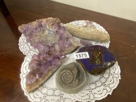 A quantity of amethyst clusters, a blue aura amethyst, fossiled wood and an ammonite fossil
