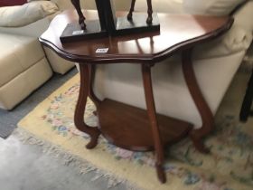 An irregular bow fronted side table