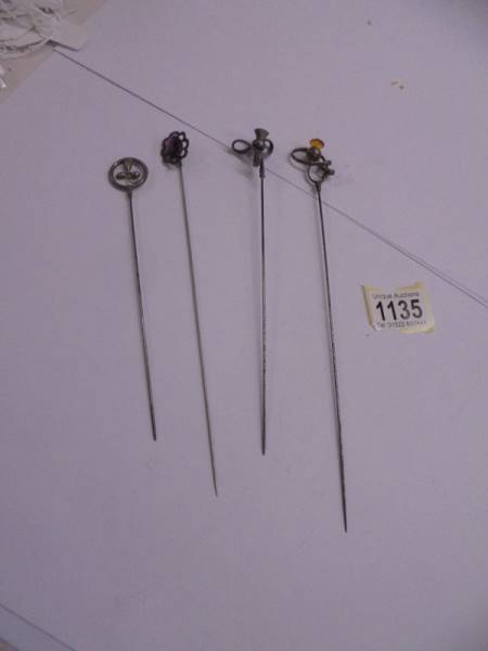 Four unmarked early 20th century hat pins.