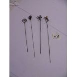 Four unmarked early 20th century hat pins.