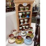 17 egg cups on pine display stand