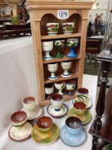 17 egg cups on pine display stand