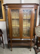 A Victorian bow front display cabinet