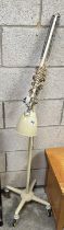 A vintage floor standing angle poise lamp on wheels