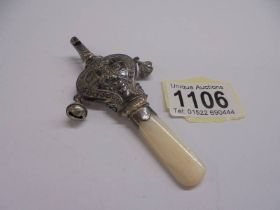 A 19th century silver and mother of pearl rattle with bells and whistle.