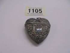 A heart shaped silver pill box/pendant.