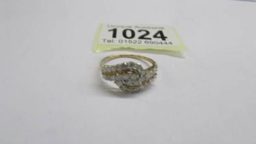A yellow gold multi diamond swirl ring, size R half. 2 grams.