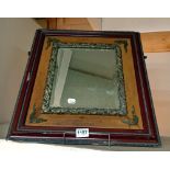 A Bevel edged mirror in a wood and metal frame.