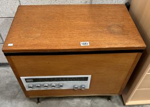 A retro teak record player cabinet with a Garrard record player