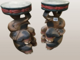 A pair of carved wooden elephant stools