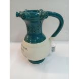 A Chinese pottery puzzle jug. Height 22cm