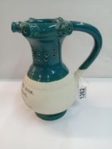 A Chinese pottery puzzle jug. Height 22cm