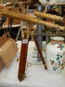 A brass telescope on tripod stand.