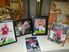 Four framed and glazed football related pictures and one unframed.