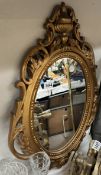 An oval gilt framed mirror. COLLECT ONLY.
