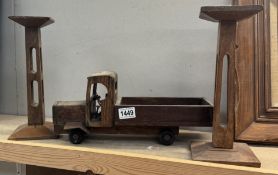 A wooden lorry and a pair of wooden candleholders.