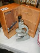 A cased student microscope.