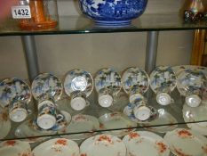 Ten Japanese tea cups and saucers.