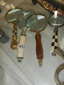 Four assorted magnifying glasses.