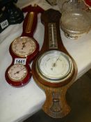 An oak barometer and one other.