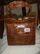 A crocodile skin hand bag.