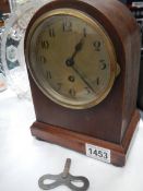 A mahogany cased mantel clock in working order.