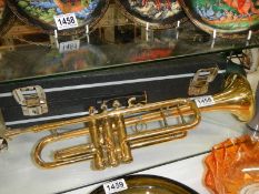 A cased brass trumpet.