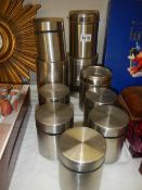 A quantity of stainless steel canisters.