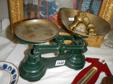 A pair of vintage style kitchen scales with weights.