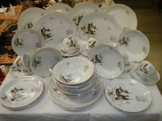 In excess of 30 pieces of Ironstone tableware decorated with flying ducks. COLLECT ONLY.