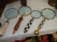 Four assorted magnifying glasses.