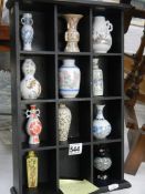 A collection of eleven miniature vases on shelf. COLLECT ONLY.