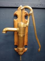 Brass pump mounted on oak plaque {H 60cm x W 36cm x D 45cm }.