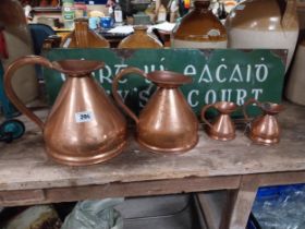 Set of four graduated copper haystack measures. {28 cm H x 30 cm Dia. to 12 cm H x 13 cm Dia.}