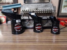 Three Harley Davidson graduated oil measures. {27 cm H x 29 cm W x 15 cm D to 18 cm H x 10 cm W x 10