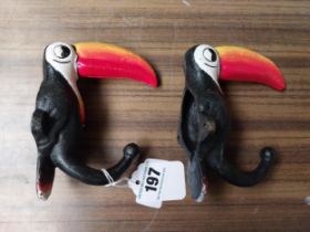 Two cast iron Guinness Toucans in the form of coat hangers. {14 cm H x 11 cm W}.