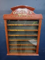 Ogden's cigarettes dispensing advertising cabinet with seven pull out brand name drawers {H 77cm x W
