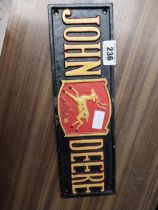 John Deere cast iron advertising sign. {5 cm H x 40 cm W}.