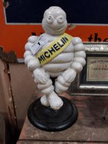 Cast iron Michelin Man advertising figure on revolving stand. {30 cm H x 6 cm W x 13 cm D}.