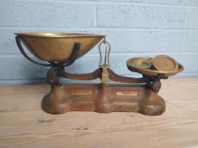 Early 20th. C. brass & cast iron shop scales with weights { 23cm H X 48cm W X 20cm D }.