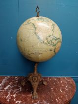 Early 20th C. world globe on cast iron decorative tripos base. {58 cm H x 33 cm W x 30 cm D}.