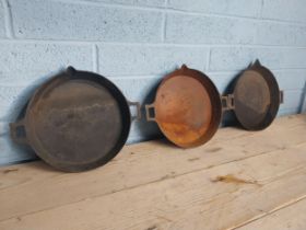 Three early 20th. C. cast iron pans. { 5cm H X 37cm W X 31cm D }.