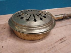 1950's brass bed warmer with mahogany handle. {101 cm H x 24 cm W x 9 cm D}.